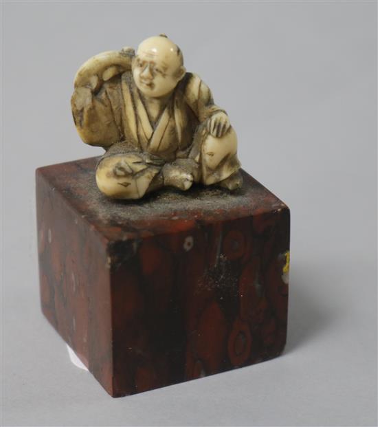 A Japanese ivory figure, 1in., on marble plinth